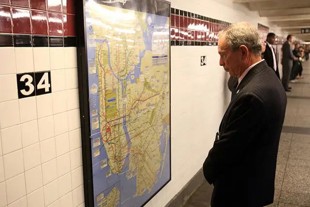 Mayor Bloomberg looking at a subway map at the Penn Station subway stop in 2010